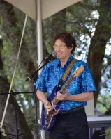 Doug at mic 60th bday concert 2016