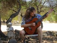 Doug playing on the lawn at Rainbowland, photo op for Gallery of Angels